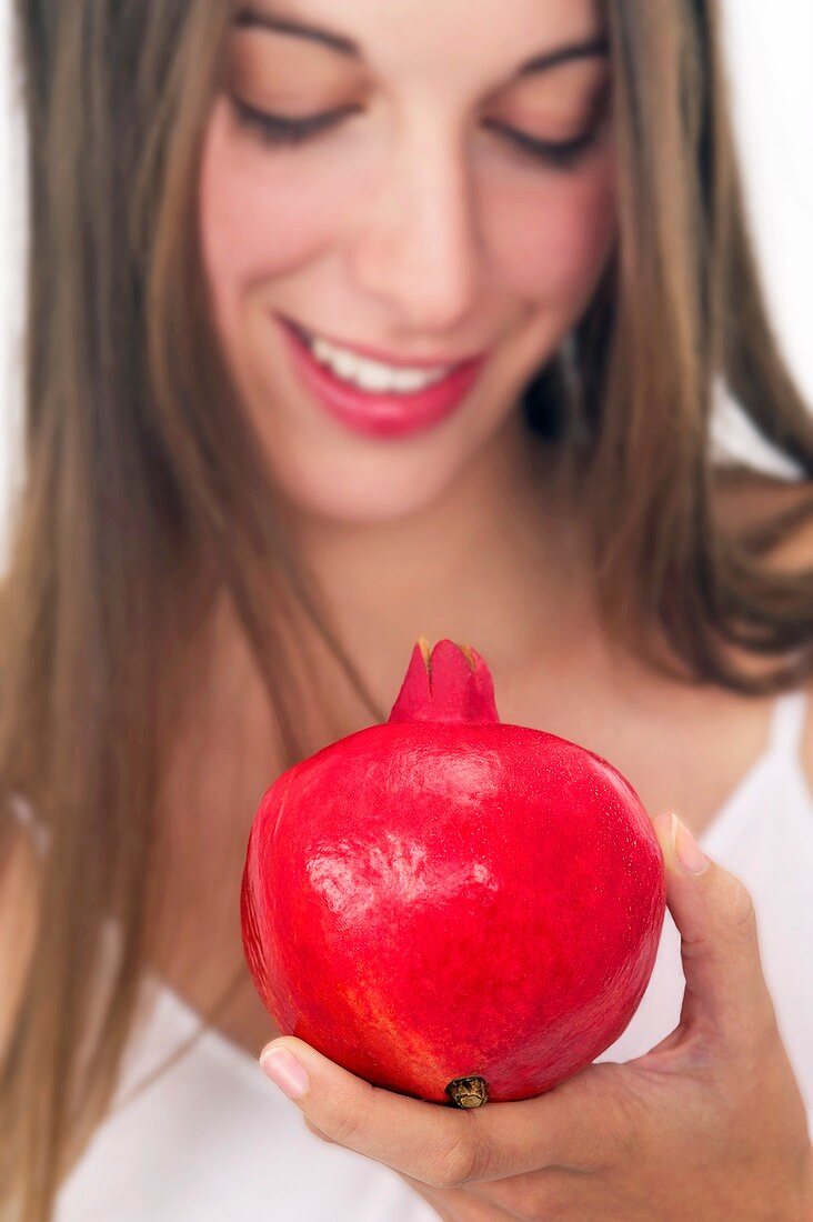 Woman holding a pomegranate