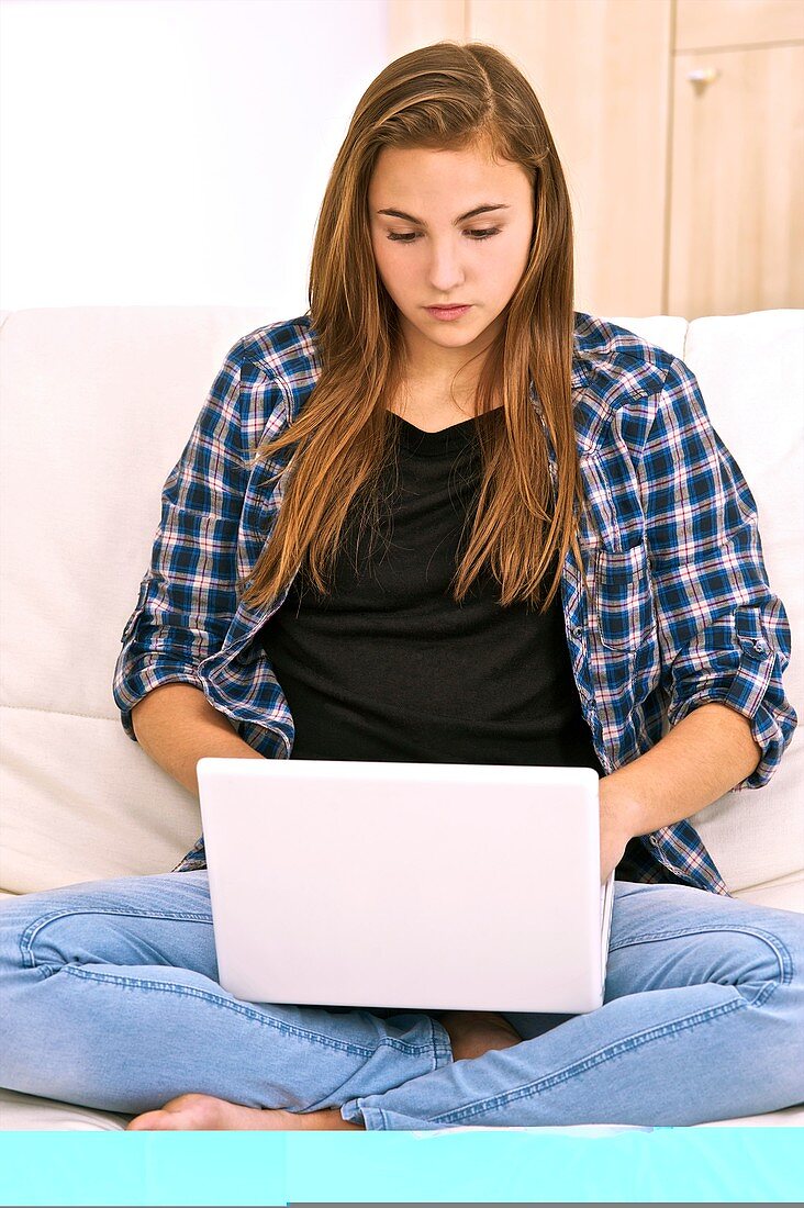 Teenager using a laptop computer