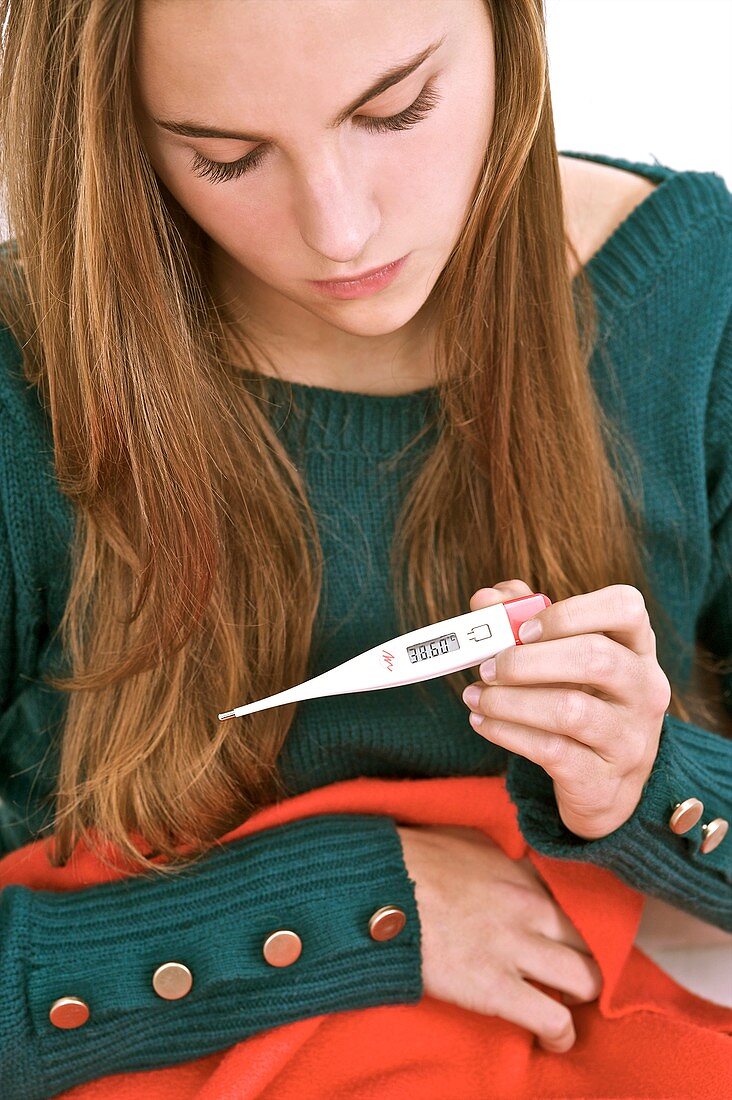 Teenager with digital thermometer