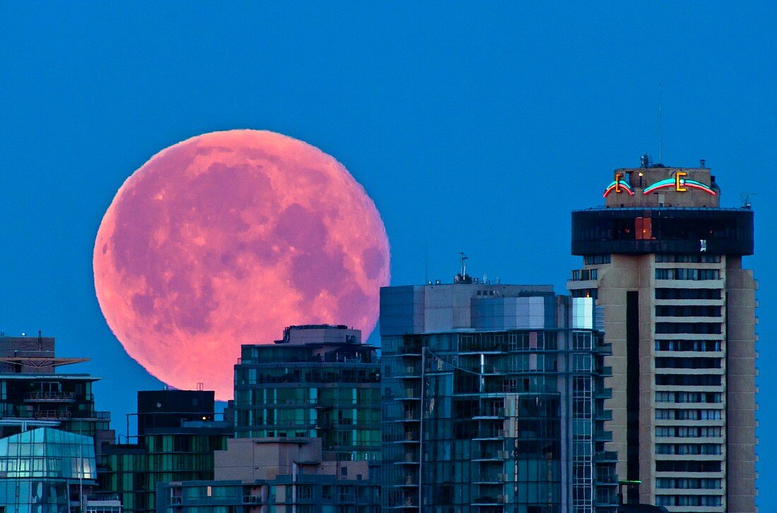 Moon setting over Vancouver skyline
