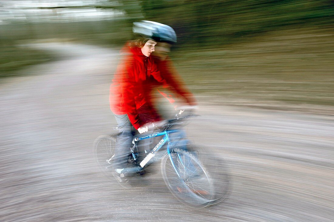 Teenage boy riding a bike at speed