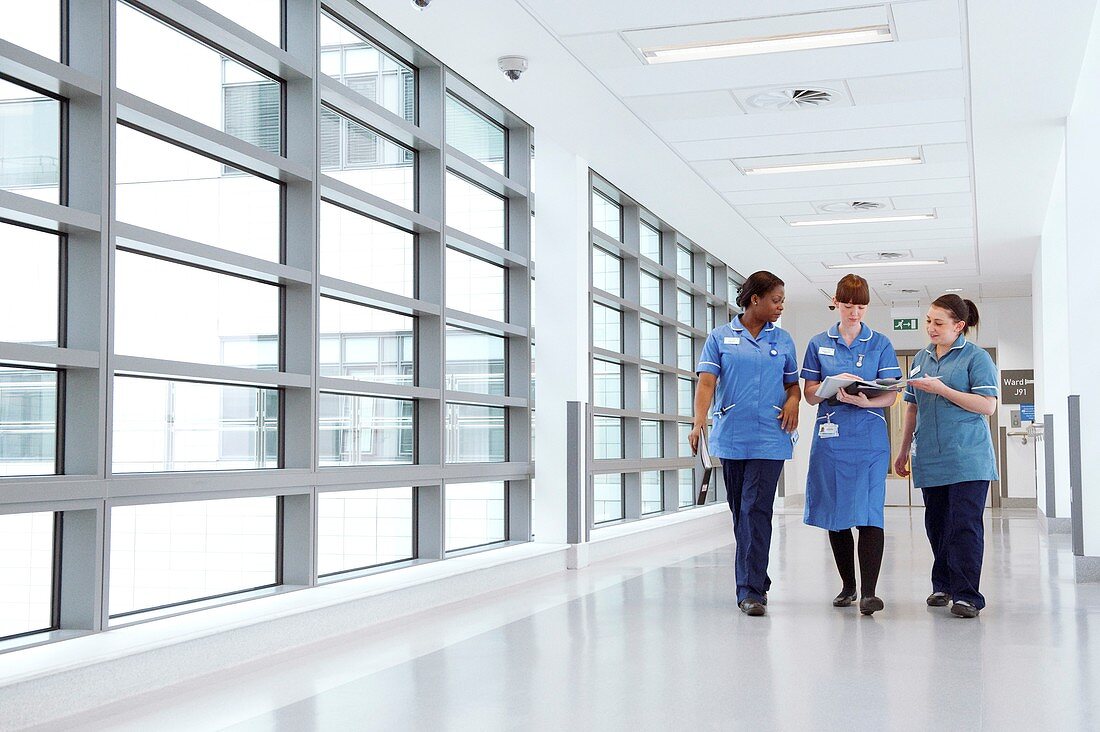 Nurses walking along hospital corridor