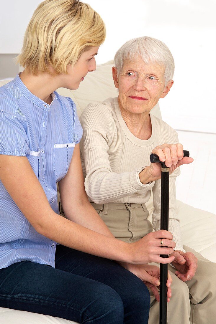 Elderly woman and carer