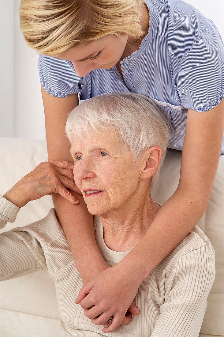 Elderly woman and carer