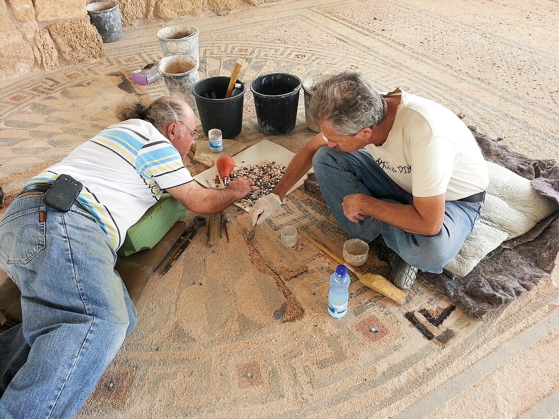 Archeologists restore a mosaic floor