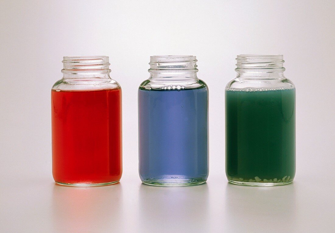 Three jars containing red cabbage juice