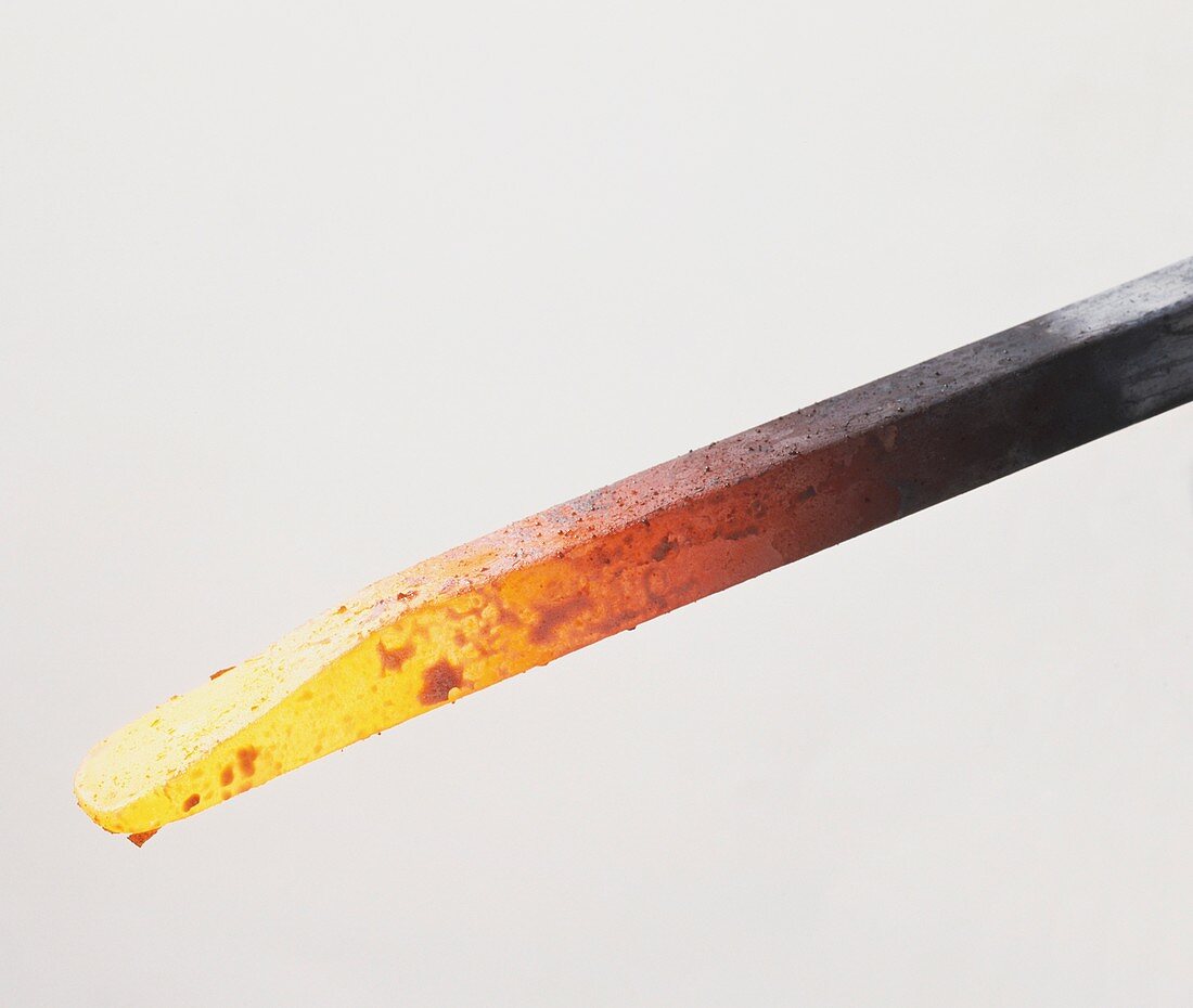 Red-hot metal rod reaching white heat