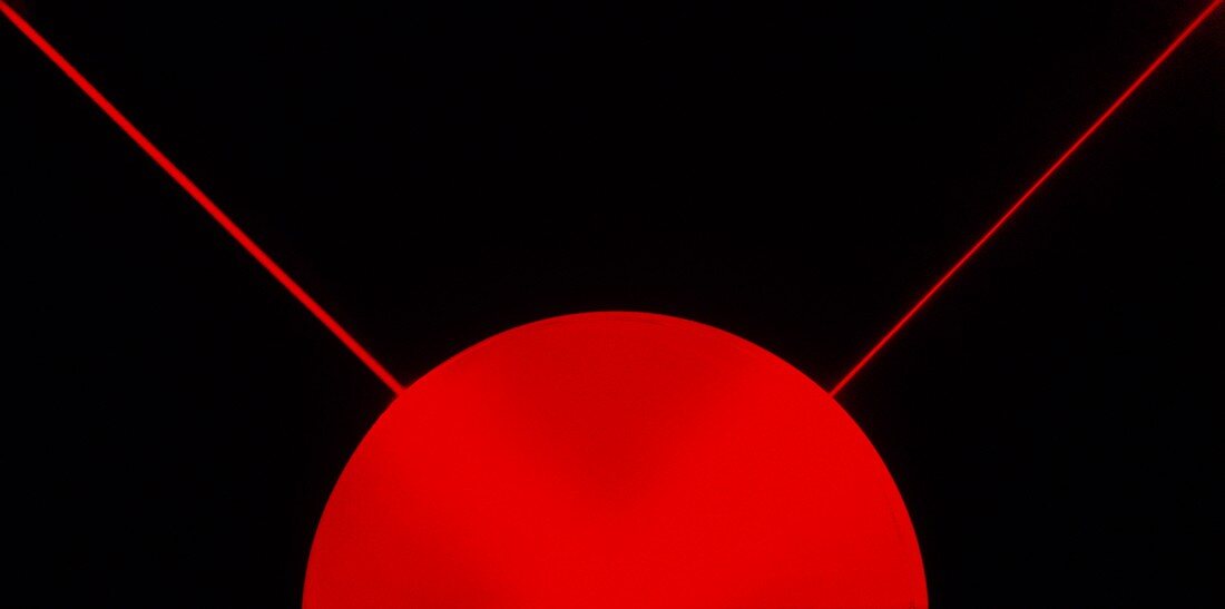 Red laser beam on black background