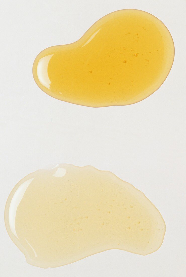 Droplet of yellow oil beside a droplet