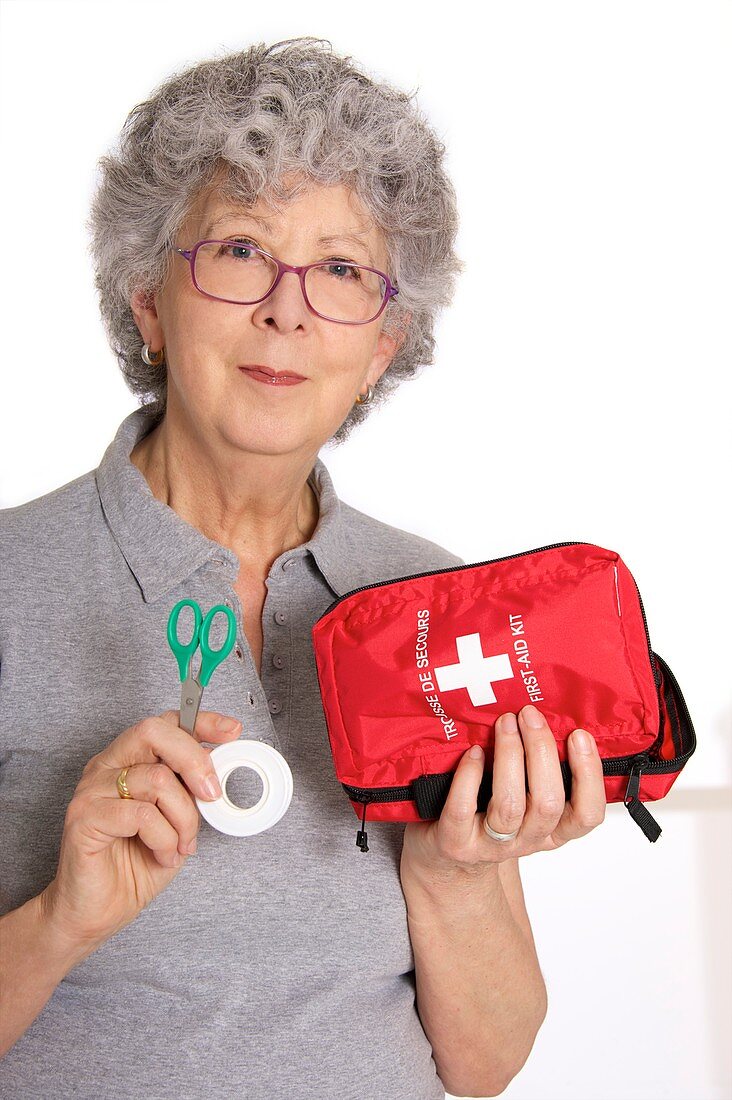 Woman holding first aid kit