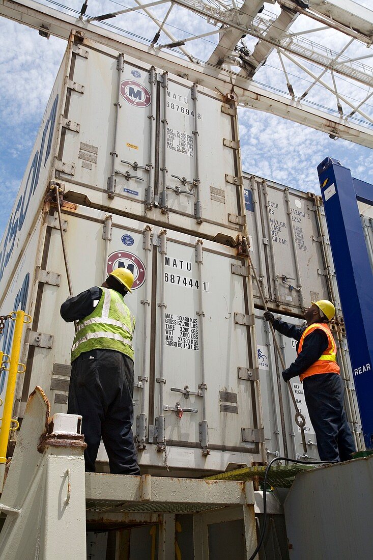 Port workers handling cargo containers