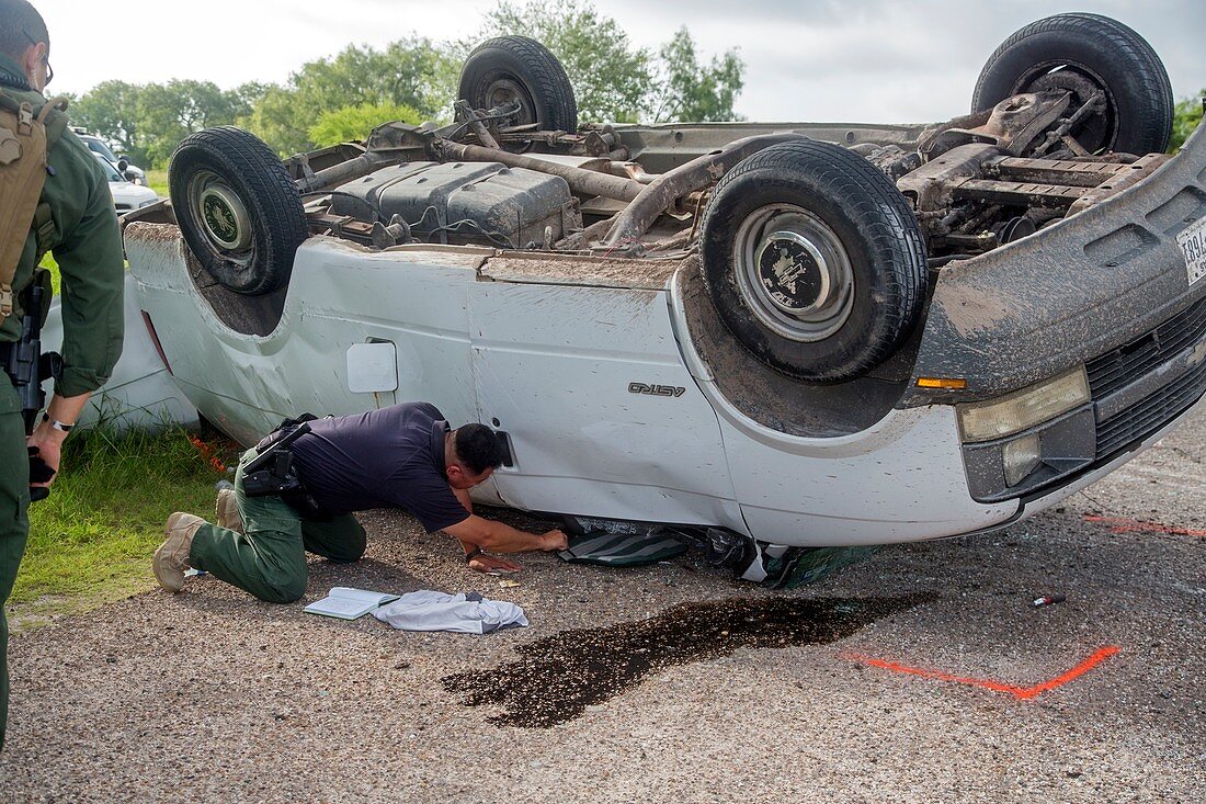 Border Patrol officer inspecting a crash