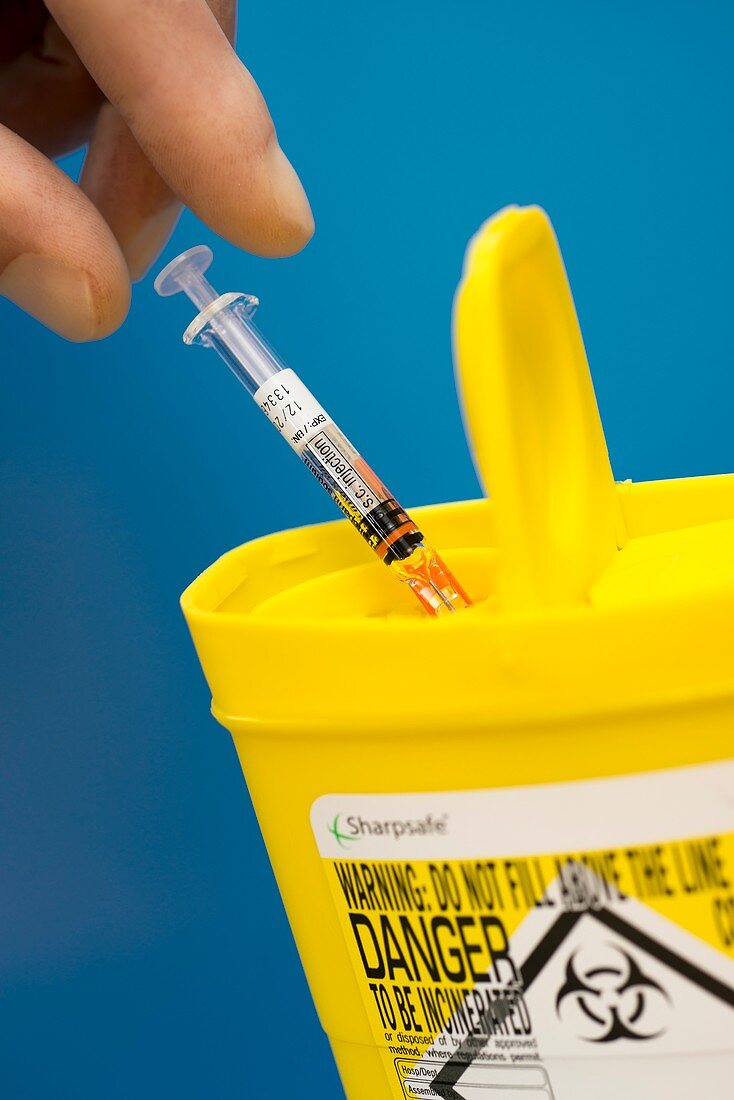 Syringe disposal in a sharps bin