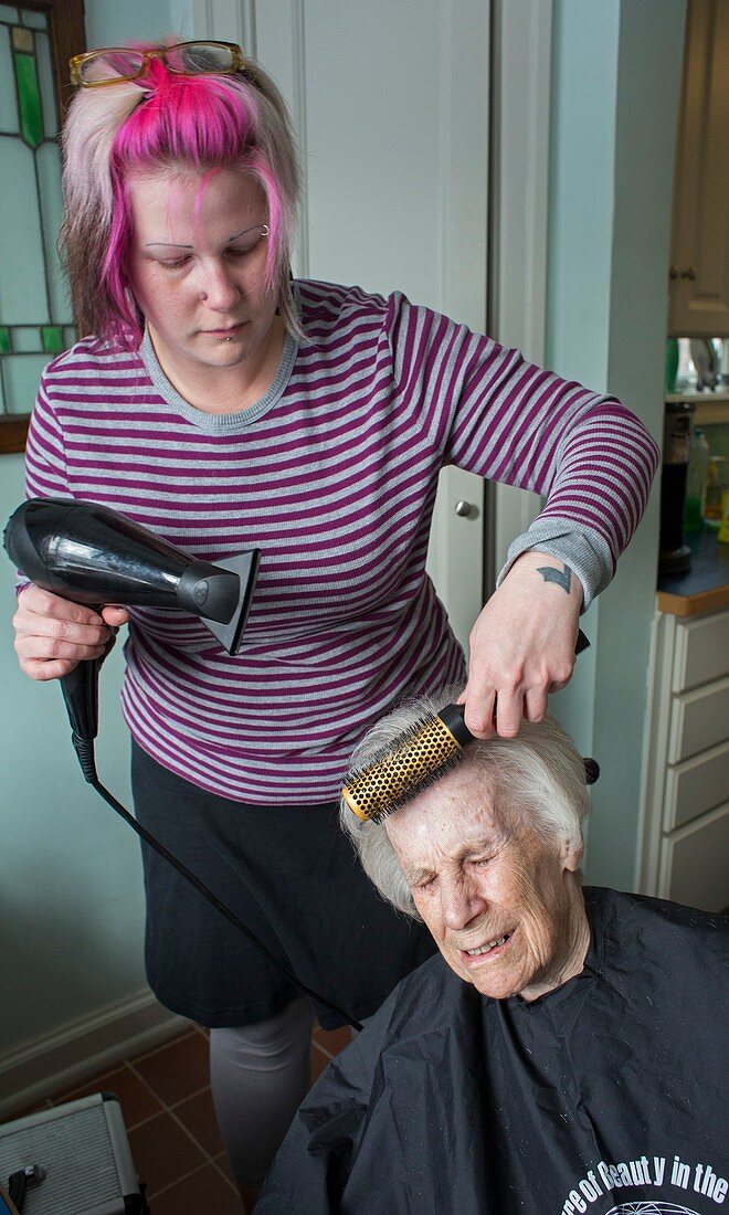 Elderly lady having her haircut