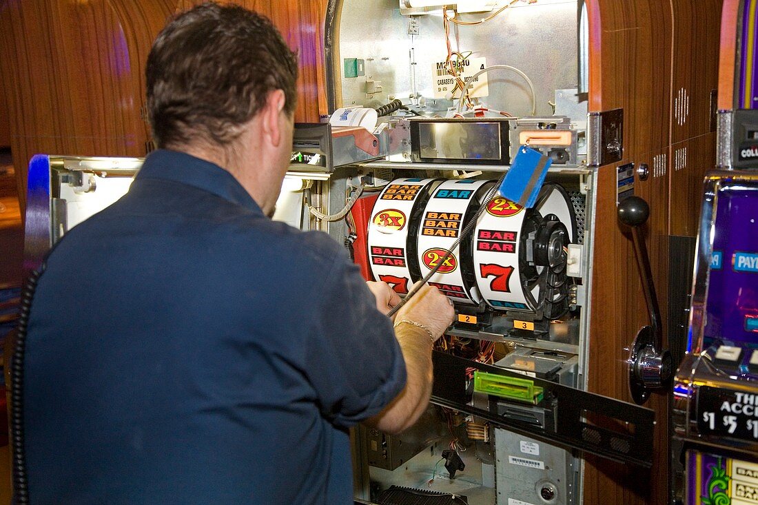 Technician servicing a slot machine