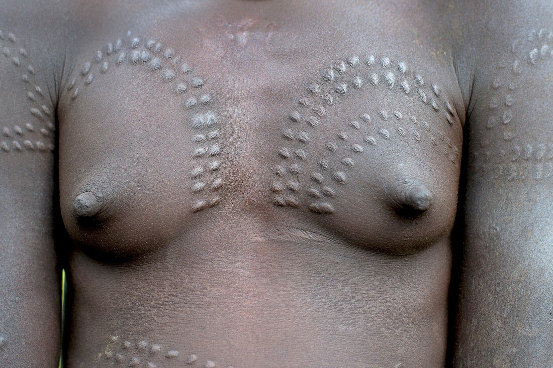 Young Mursi woman with body scarification