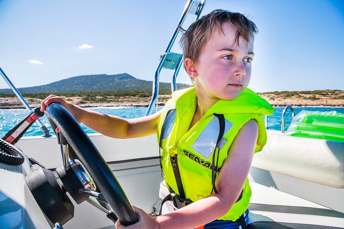 Boy driving a speedboat
