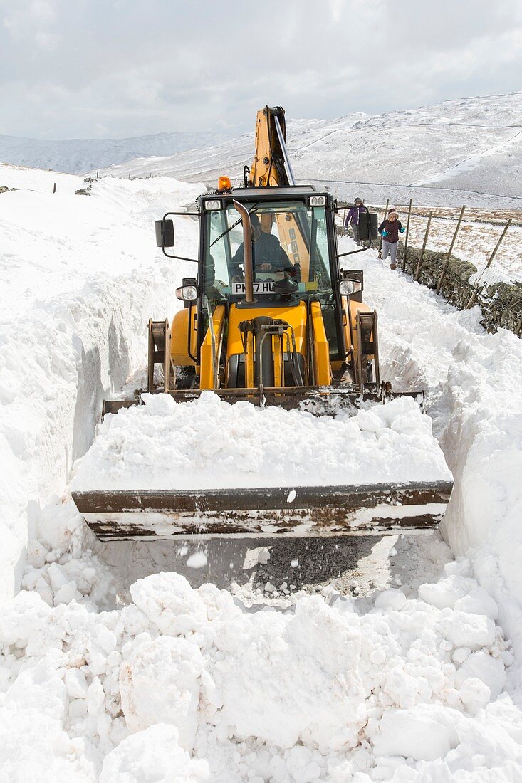 Digger clearing snow drifts