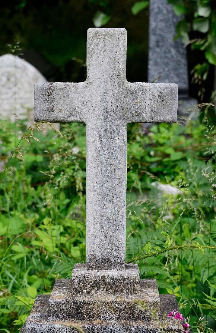 Stone cross in an urban cemetery