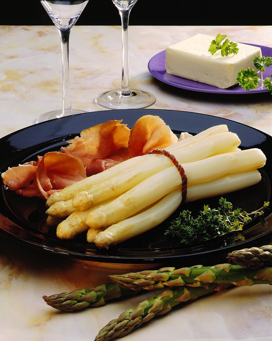 White asparagus with air-dried ham and a piece of butter