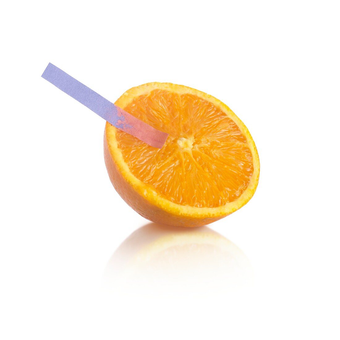Litmus paper test on an orange