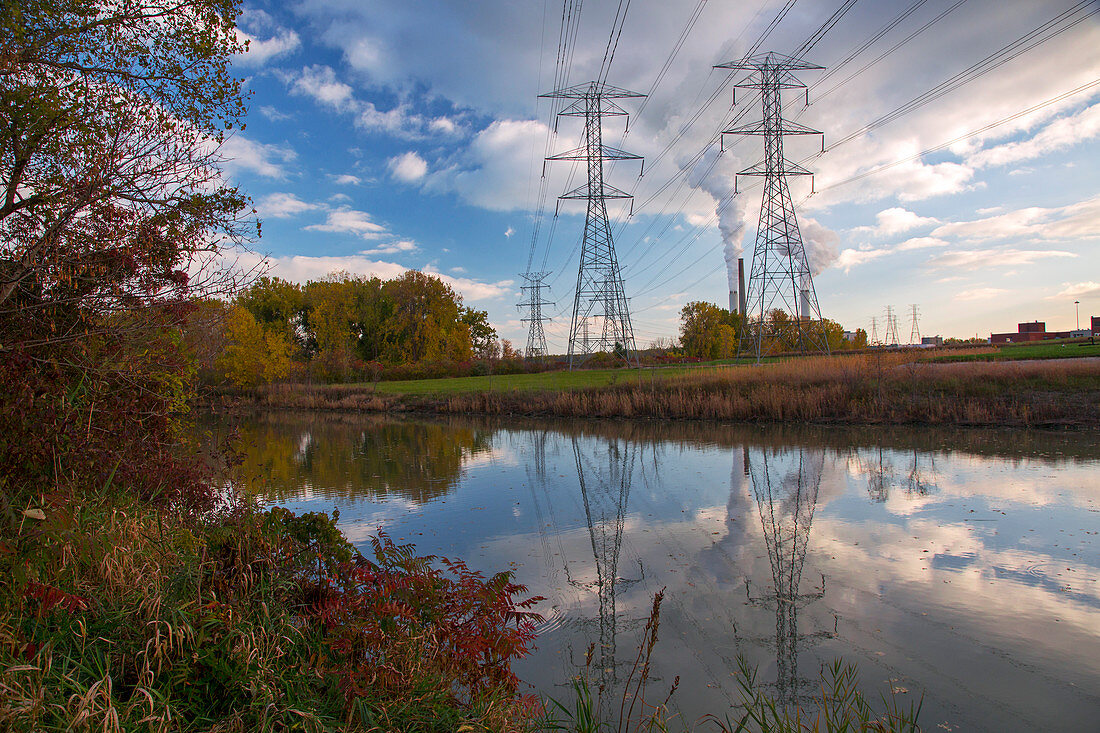 Electricity pylons by a lake
