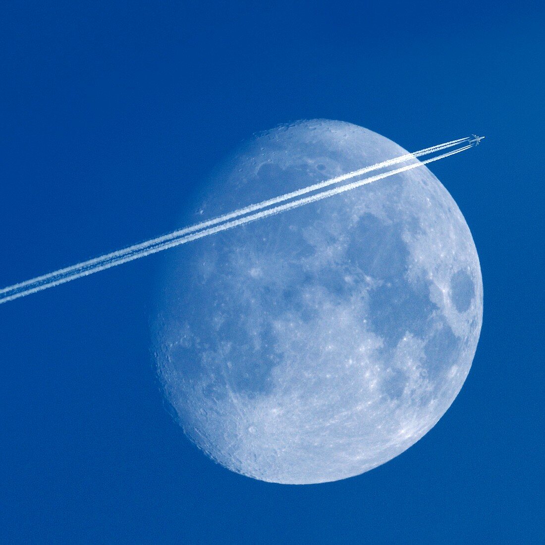 Moon and aeroplane contrails