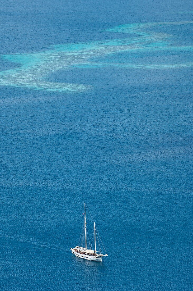Yacht with coral reef behind