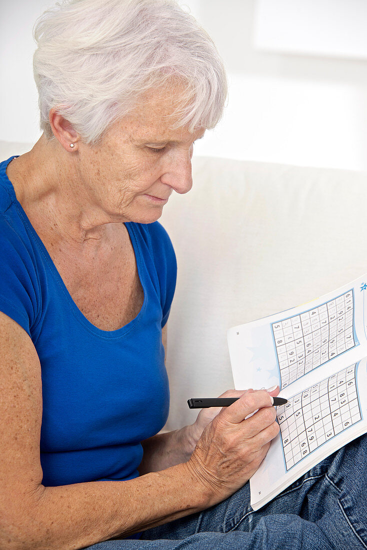 Older lady playing Sudoku