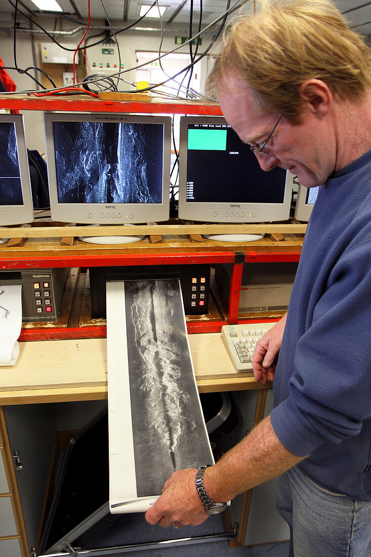 Marine geologist studying seafloor map