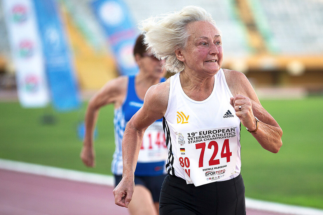 Silver-haired female athlete running