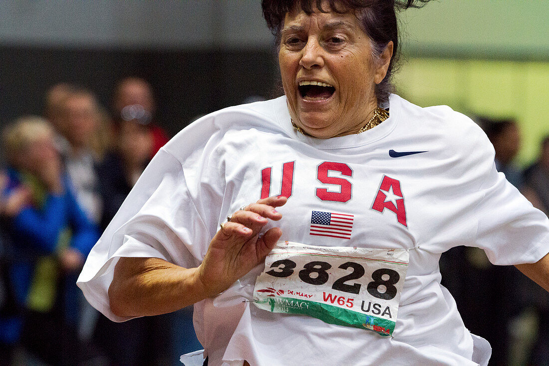 Joyful older female athlete running