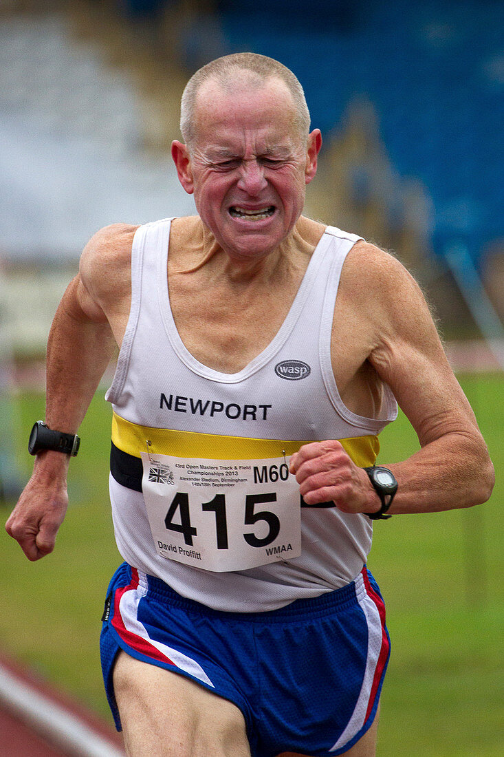 Senior male athlete runs through the pain