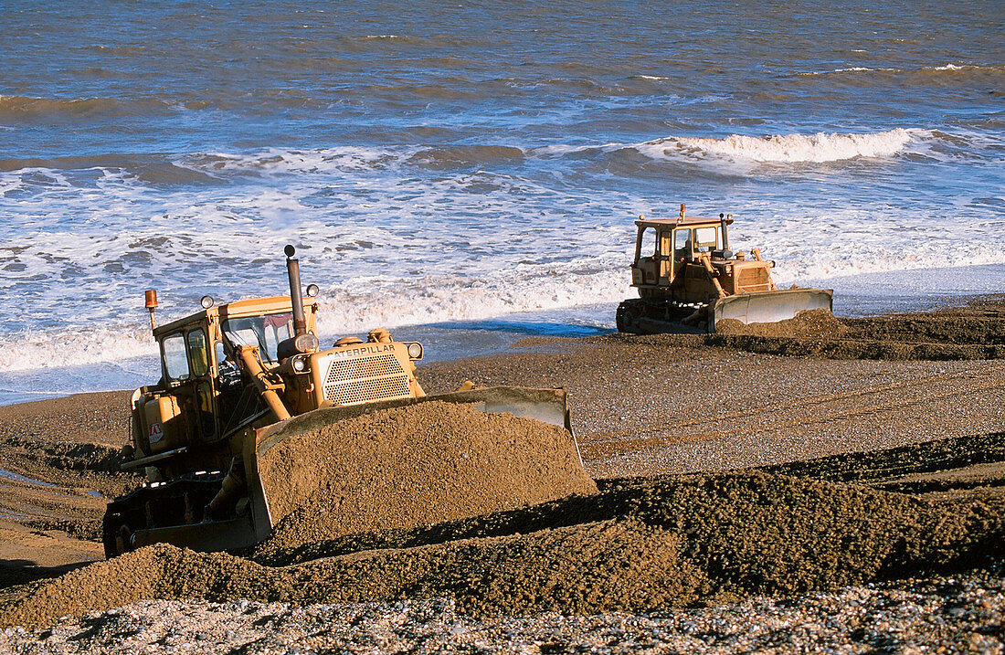 Bulldozers rebuilding beach