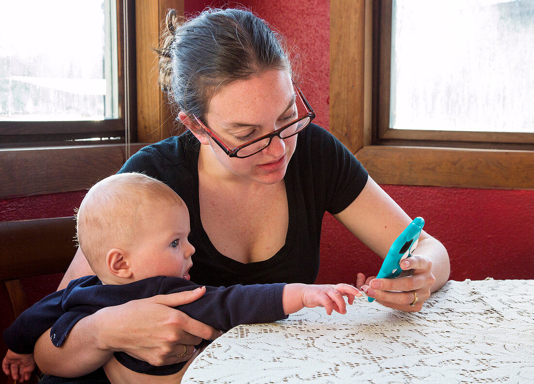 Mother and baby using a mobile device
