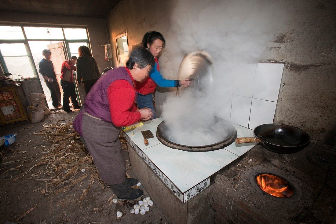 A Chinese family cooks on a stove