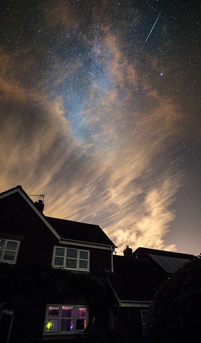 Perseid meteor trail over houses