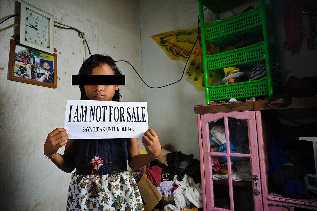 Child with sign,Indonesia