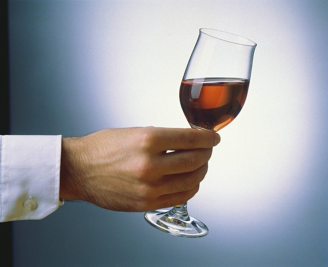 Glass of Oloroso held at an angle: test of colour and aroma