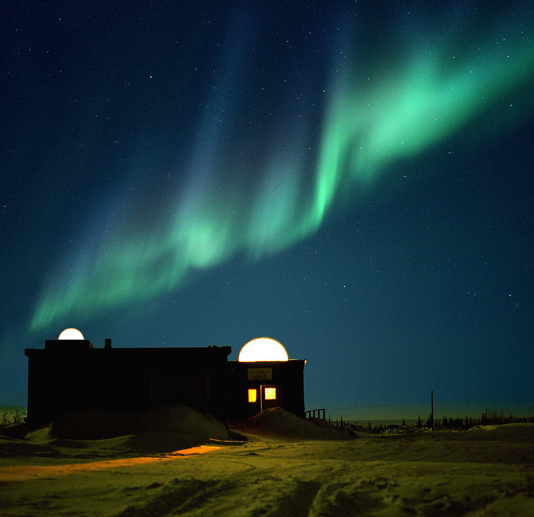 Aurora borealis over observation domes in Canada
