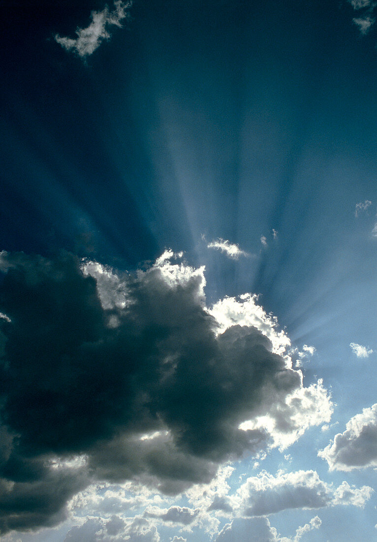 Sun rays shining from behind a cloud