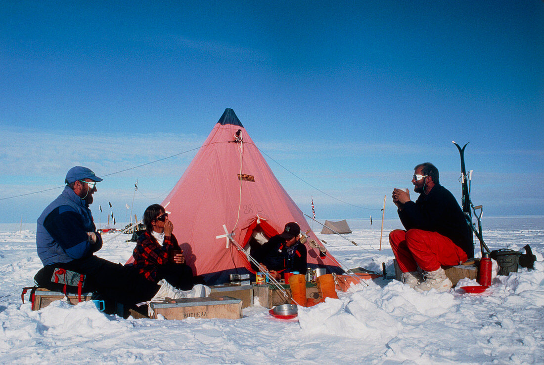 Antarctic research team relaxing outside tent