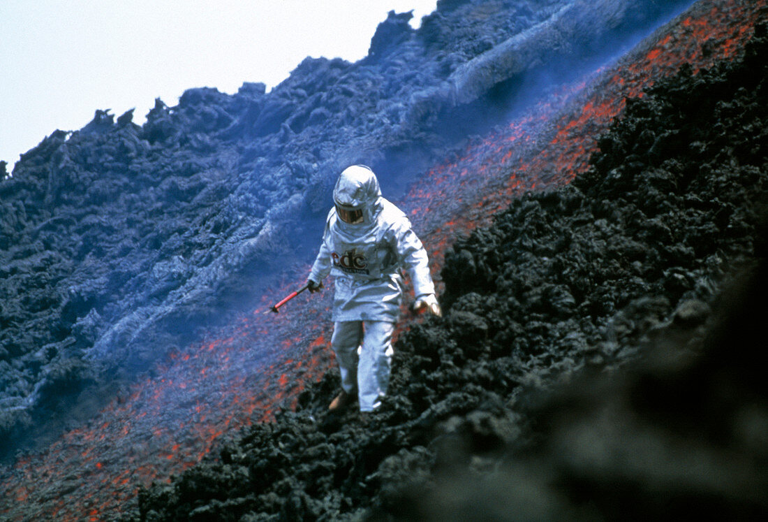 Volcanologist by Mount Etna lava flow