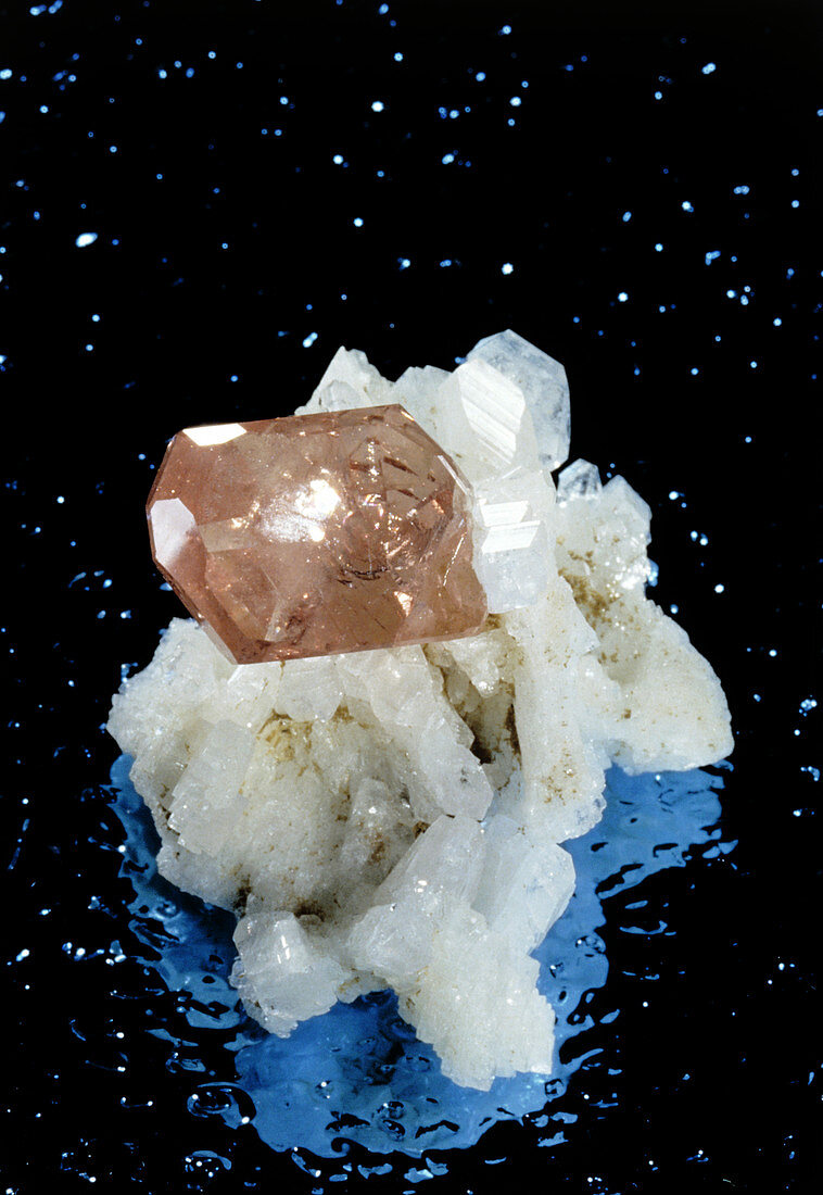 Crystal of pink apatite growing on albite