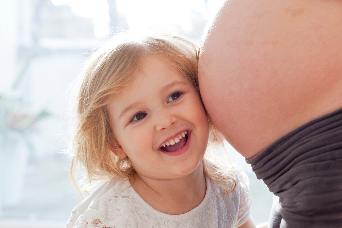 Girl with pregnant mother