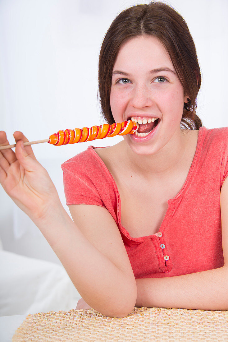 Teenage girl eating lollipop