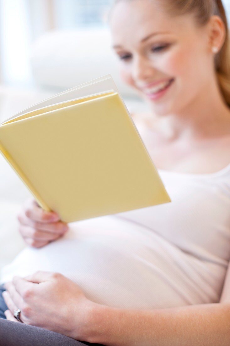 Pregnant woman reading book