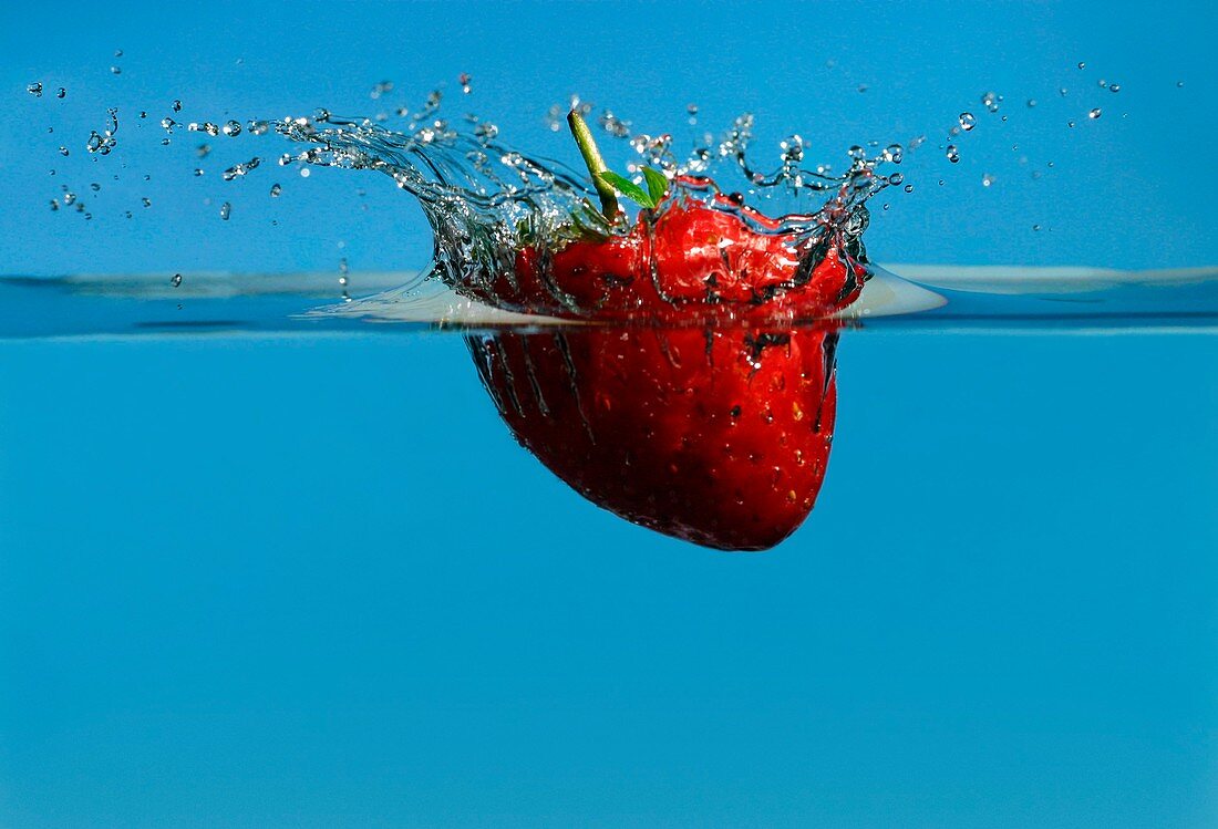 Strawberry dropped into water