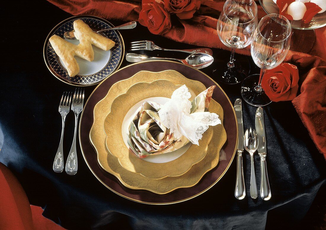 Ein festliches Gedeck mit lila & goldenen Tellern, Besteck