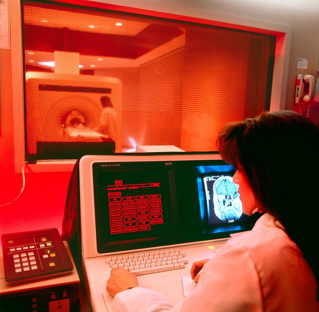 Radiographer conducting MRI brain scan of child